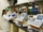 person in white medical scrub suit standing beside white and blue hospital bed