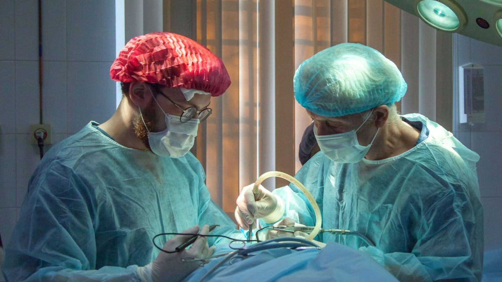 two men wearing blue lab coats